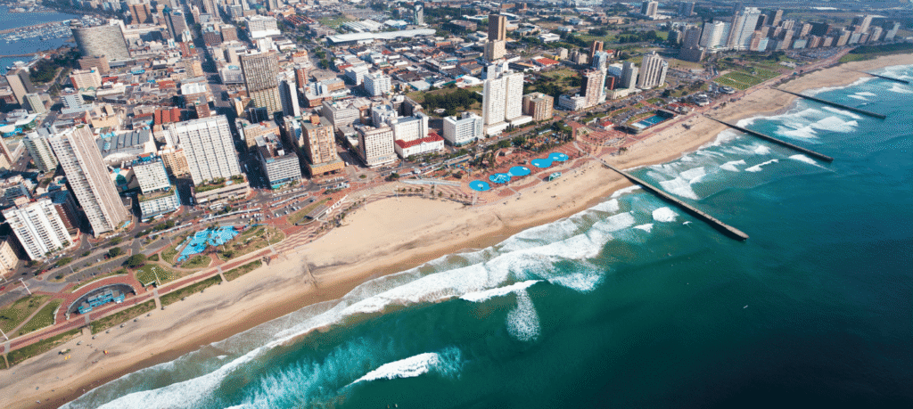 Durban beachfront with warm Indian Ocean waves and festive season visitors in 2025.